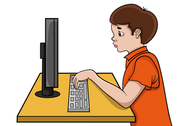 Child typing at the computer learning keyboard hand position